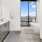 Bath with dual vanity, large mirror and glass enclosed showerA