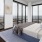 Bedroom with large bed, ensuite. queen bed and nightstands.