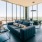 Resident clubhouse with ample seating, fireplace, demo kitchen and TVs